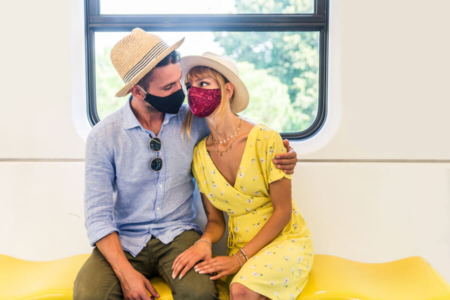 Couple wearing mask on subway