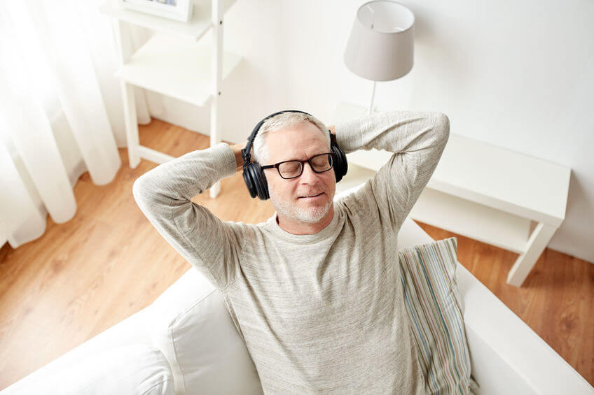 Man sitting on couch listening to music