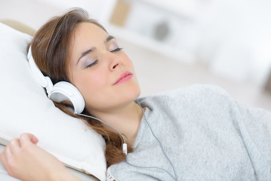 Woman asleep with headphones on