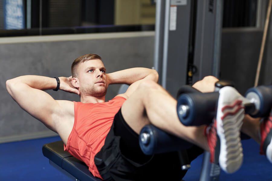 Man doing sit-ups in gym