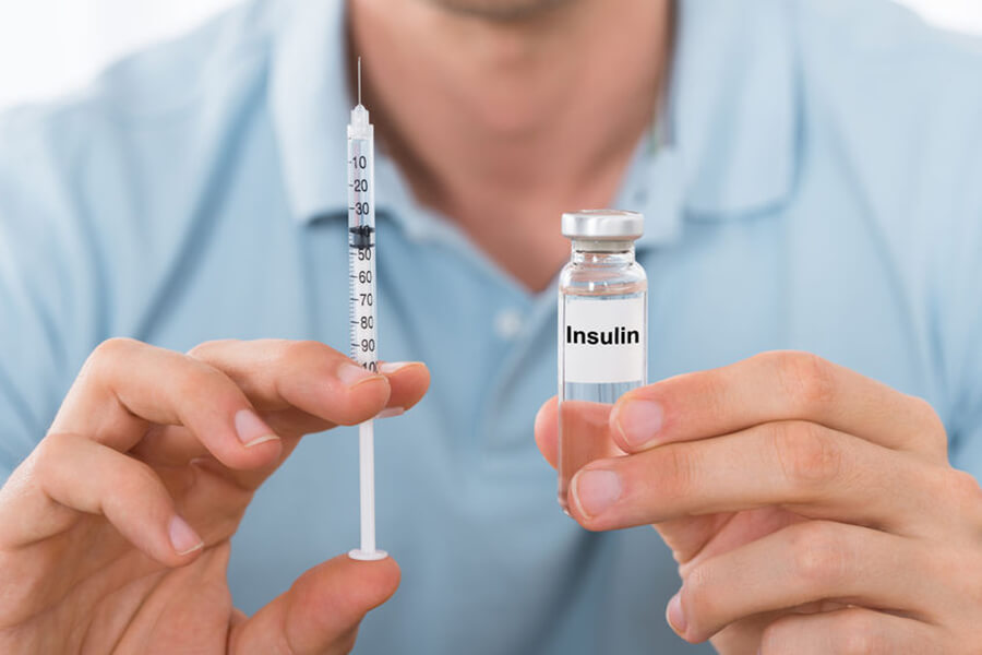 Man holding insulin vile