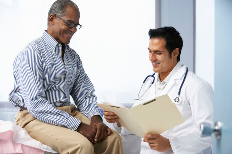 Older man talking with doctor about results