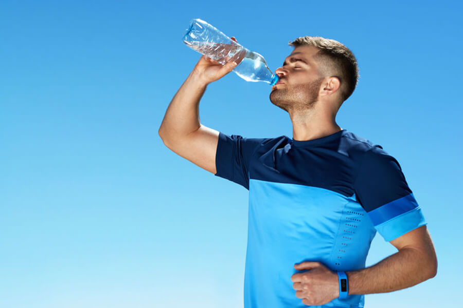 Man drinking water in sun