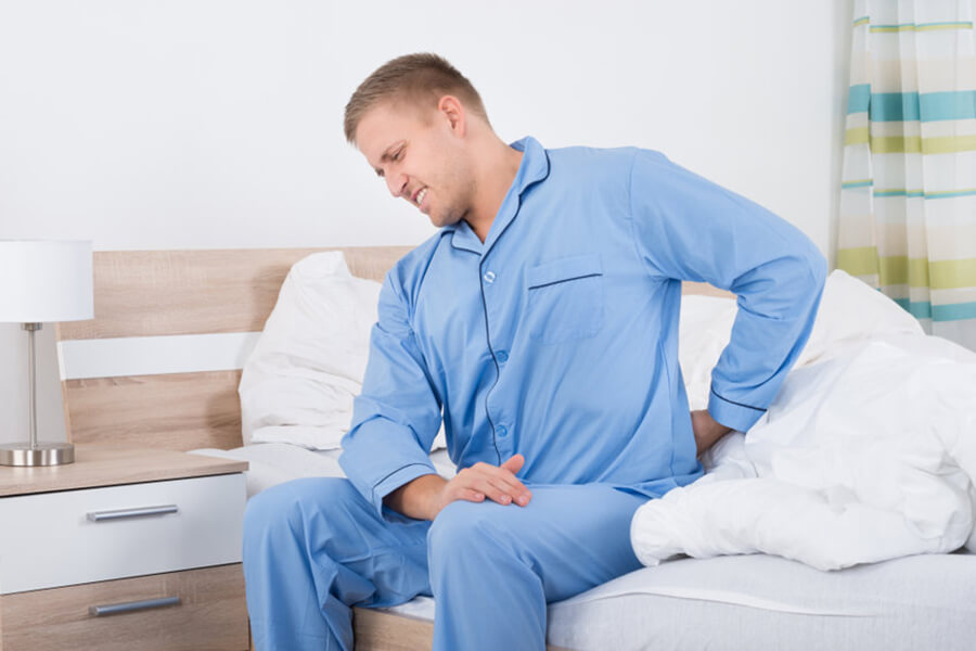 Man in pajamas with back pain
