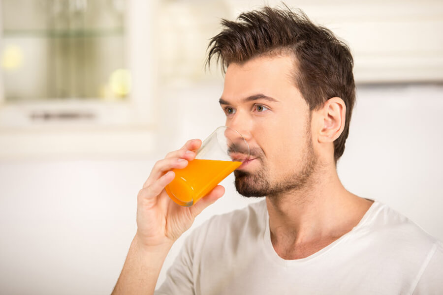 Male drinking orange juice