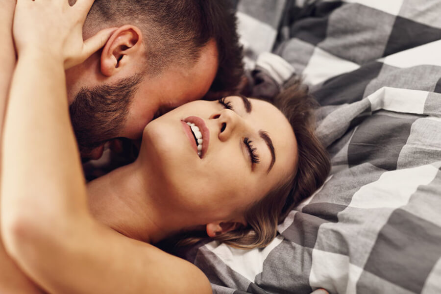 Couple being intimate in a bed