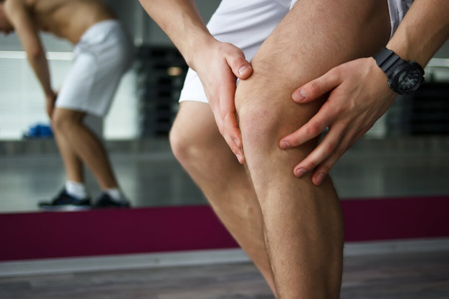 Athlete holding knee in pain