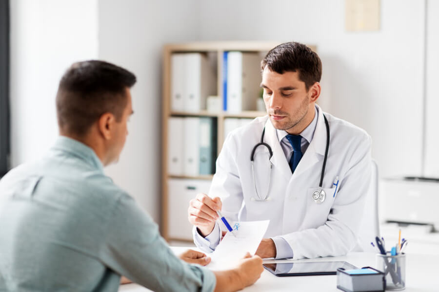 Male doctor speaking to male patient